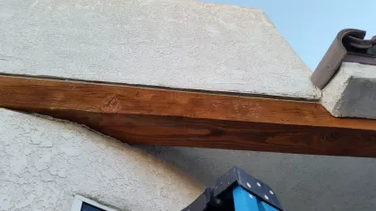 Bee removal scene in Bullhead City, Arizona, with inspection of a stucco wall